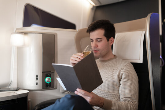Man drinking Glass of Champagne on first class flight