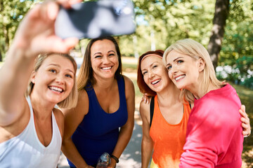 Group of women taking selfie after outdoor exercising in park