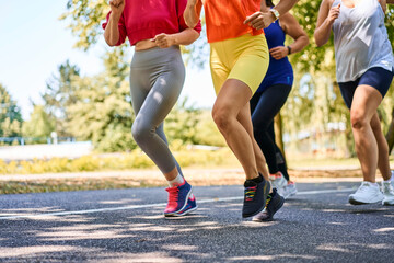 Fototapeta premium Close-up of group of women jogging together in park