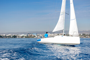 Sailing crew on sailboat during regatta