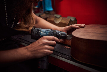 Drilling into an acoustic guitar