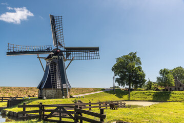 Enkhuizen, Netherlands, June 2022. The mill on the grounds of the Zuiderzee Museum in Enkhuizen. - obrazy, fototapety, plakaty