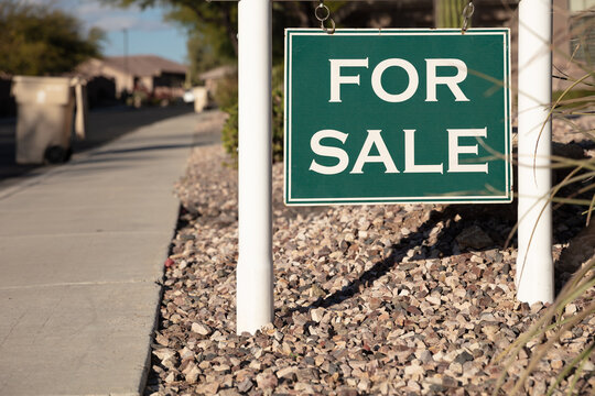 For sale sign in wealthy suburban street