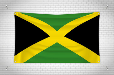 Jamaica flag hanging on brick wall. 3D drawing. Flag attached to the wall. Neatly drawing in groups on separate layers for easy editing.