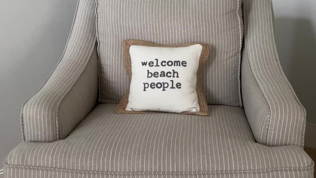 A pillow that says welcome beach people in a condo in Florida.