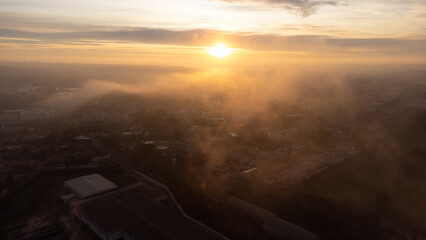 Sunrise, beautiful sunrise on a cold foggy morning in a small town in Brazil, drone photo.