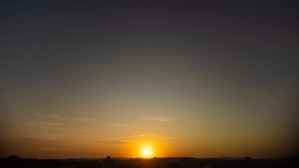 Naklejka premium Sunset, beautiful sunset over a small town in Brazil, drone photo.