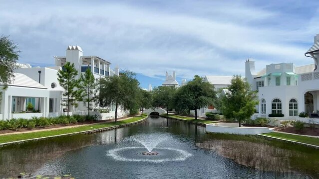 A walking path with water feature and homes in Alys Beach, Florida.