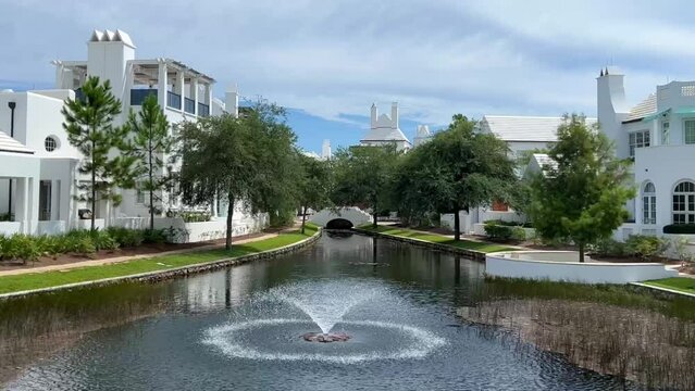 A walking path with water feature and homes in Alys Beach, Florida.