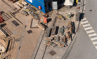 scaffolding and wood and crane stuff on the ground at a harbor dry dock