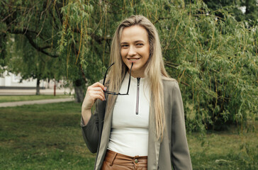 Pretty woman smiling and showing class hand gesture.