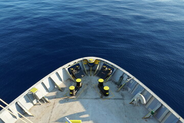 View on calm blue Mediterranean Sea and mooring station with yellow bollards, mooring rollers and...