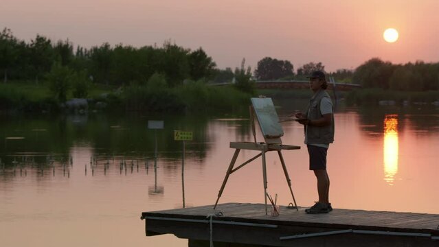 Mature man painting in park,4K