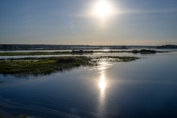 Scenic landscape with foggy river and forest on the horizon. Mystical morning landscape on the pond. Dawn over the lake.