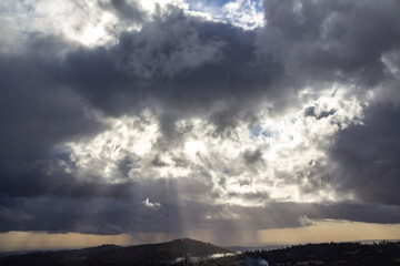 Fototapeta na wymiar light shining through storm clouds