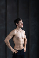 Fototapeta na wymiar Portrait of strong man on dark background. Sport workout