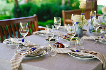 beautiful setting of a large table with snacks and flowers. 