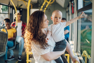 Mother and a baby riding in a bus in the city
