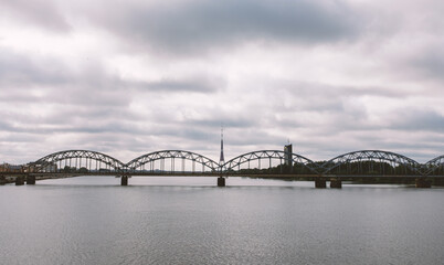 Fototapeta na wymiar Railway arch bridge under dramatic clouds.