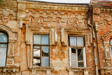 broken glass in windows of an old ruined building.