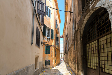A traditional narrow alley in the Jewish Medieval Quarter of the Spanish city of Palma de Mallorca, on the Balearic Mediterranean island of Mallorca, Spain.