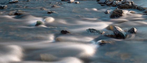 River, long exposure photo, waves and rocks