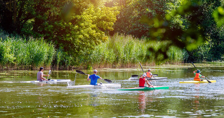 guys floating in a canoe on the river
