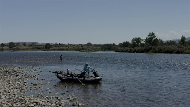 Aerial view of fly fishermen fishing from a drift boat and wading the scenic Bighorn River near Fort Smith, Montana. The Bighorn is a renowned blue-ribbon trout fishery known for brown and rainbow tro