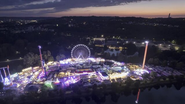 Aerial time lapse shot of a fair next to river Danube at colorful dusk