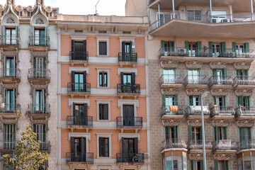 Facade of a typical apartment building in Barcelona, Spain. Exterior building with balconies and window shutters