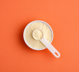 Powdered milk with nutrients in the bowl and spoon