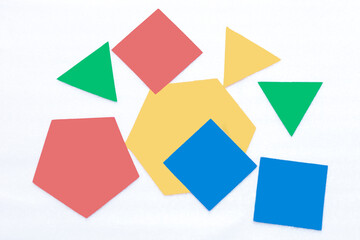 background with colored geometric shapes. Triangles, squares, pentagon and hexagon. Red, blue, green and yellow. School. Geometry 