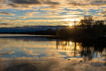 Fototapeta premium Osisko Lake on sunset time. Beautiful reflection like a mirror. Landscape of Rouyn-Noranda, Abitibi-Temiscamingue, Quebec, Canada.