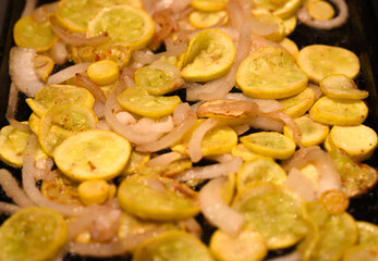 close up of sautéed yellow squash and onions.