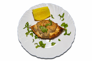 Isolated Crab cone with typical Brazilian taste with crab meat roasted inside the shell of the crustacean in the white plate with lemon and coriander.