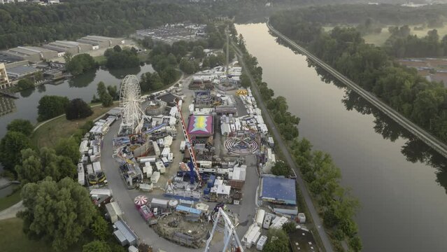 Closed fair at sunrise next to river aerial time lapse