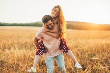 Caucasian woman enjoying piggy back ride with her boyfriend, enjoy a relaxing day in the...