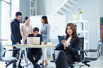 Asian portrait woman coworkers with digital tablet andstylus pen look at camera smiling feel happy....