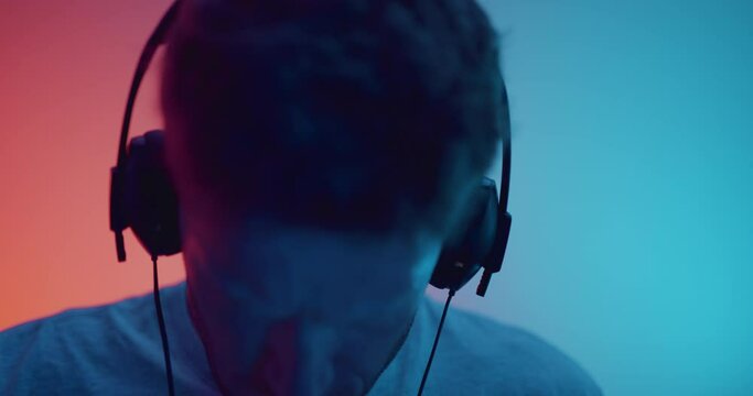 Music producer putting headphones on and listening to music