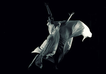 dancer in a white robe on a black background, woman dancing