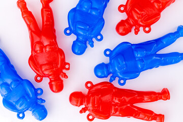 Red and blue Russian toy soldiers laying ion white background. Concept of Russian war casualties