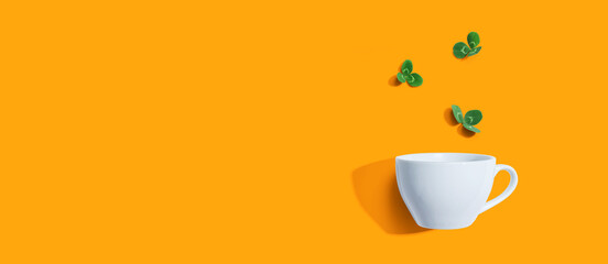 Shamrock leaves with coffee cup - flat lay