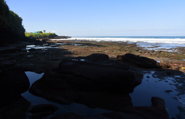 Rock formation at the south area of Bali island,with black sand beach