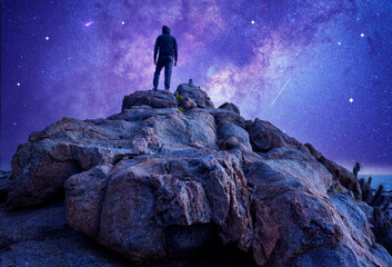 silhouette of a person standing on the rock with Milky Way and Moon background. - Powered by Adobe