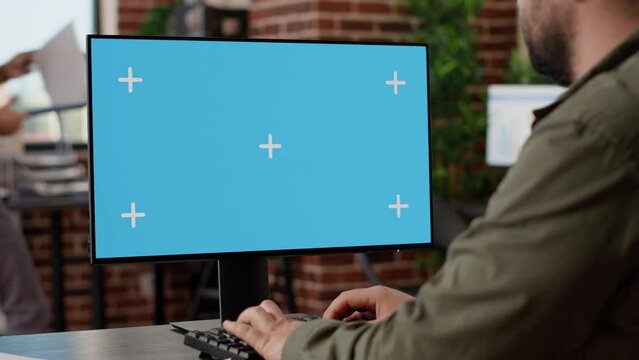 Businessman working on monitor with greenscreen template, using isolated copyspace desktop on computer. Analyzing blank mockup background on display, digital technology. Close up.