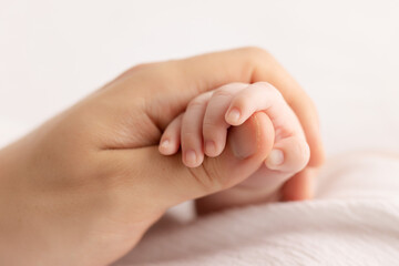 father hand holding baby`s hand