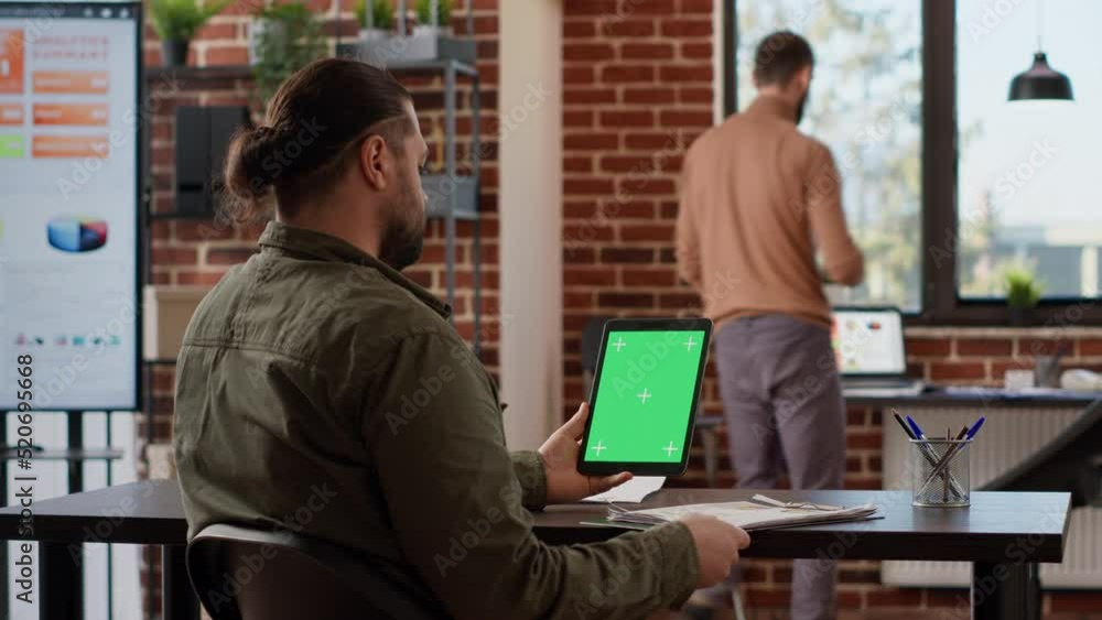 Poster businessman looking at digital tablet with greenscreen display in company office. using isolated bla