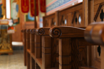 Empty wooden bench in church, closeup. Space for text
