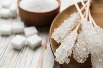 Fototapeta na wymiar Different types of sugar on white wooden table, closeup
