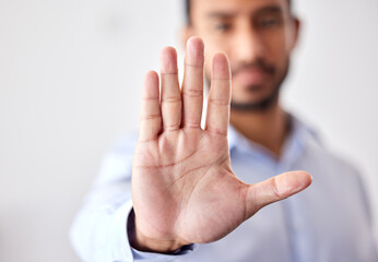 Closeup of the hand of a business man showing stop, saying no or not accepting a deal in an office...